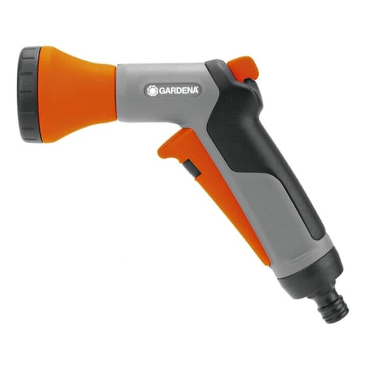 Пистолет за поливане, свързан към градински маркуч в процес на поливане